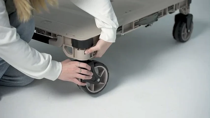 Close view of the utility cart wheel and platform connection