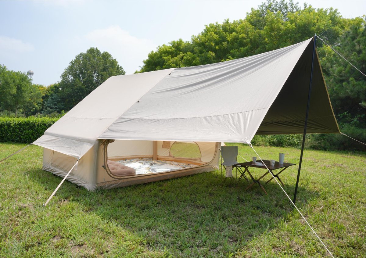 Green and khaki Pro canopy tents beside a pine lake